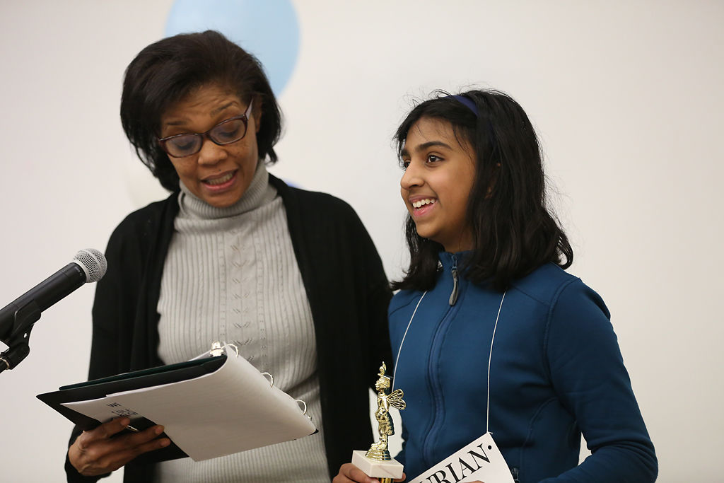 Neha Kodali, right, is awarded the 2019 Missourian Regional Spelling Bee championship trophy